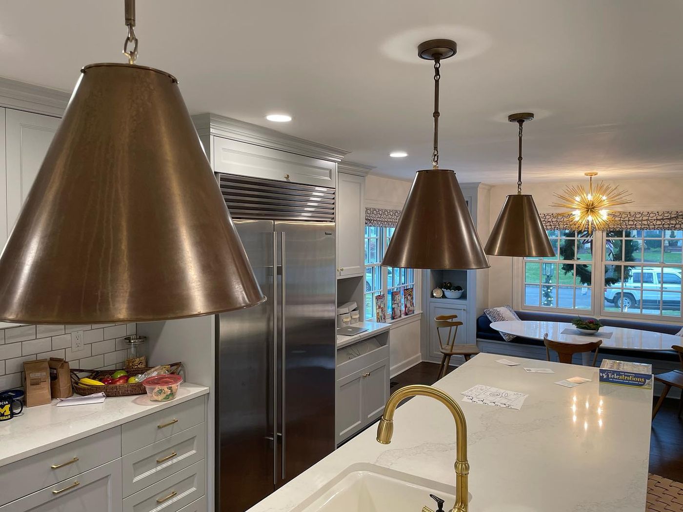 Kitchen remodel: island, brass fixtures, custom cabinetry