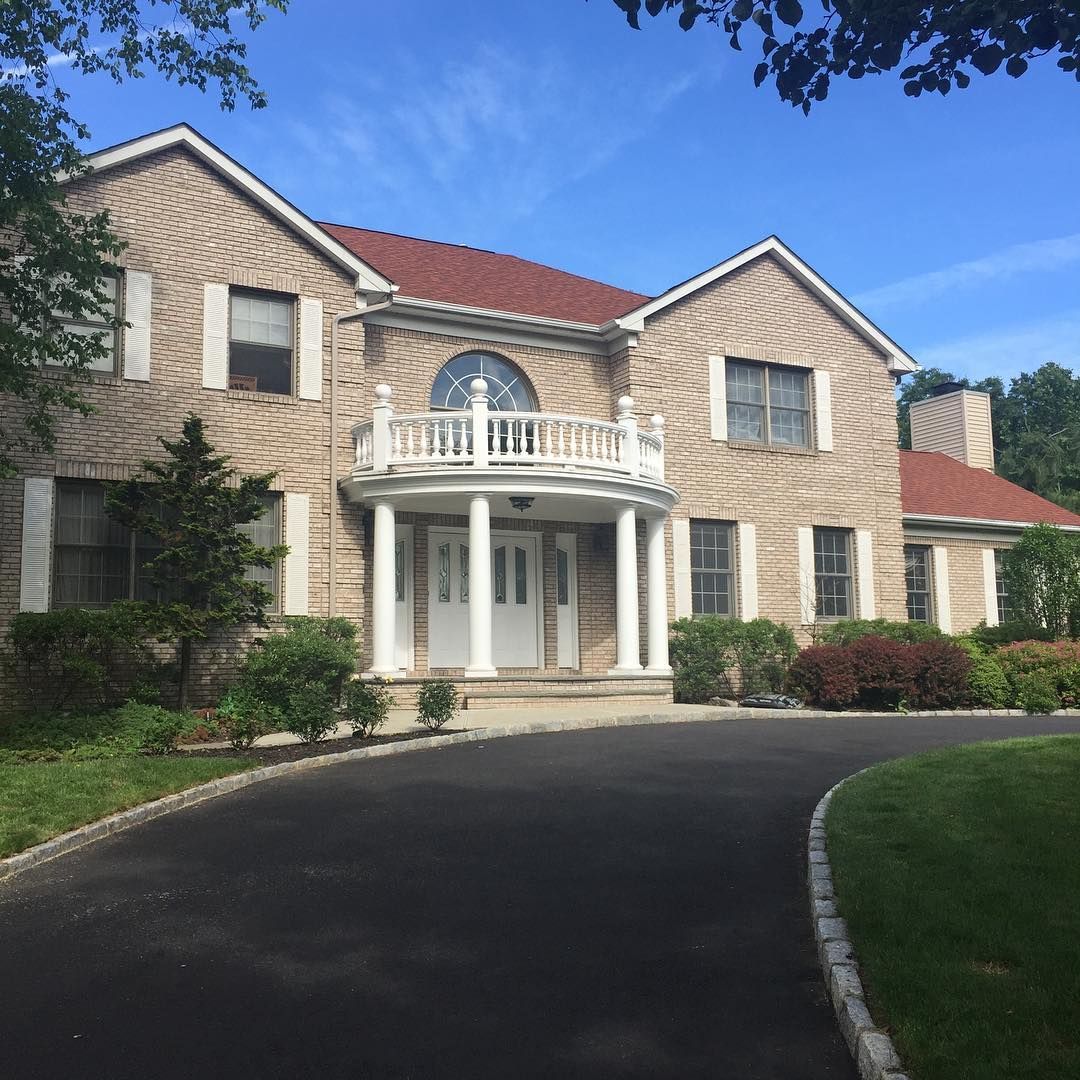 Brick colonial: new roof, portico and driveway edging